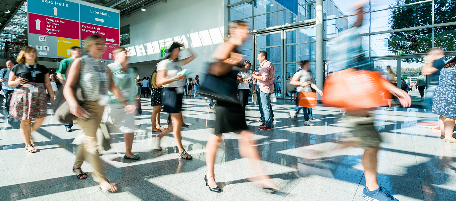 Impact XM | trade show attendees walking